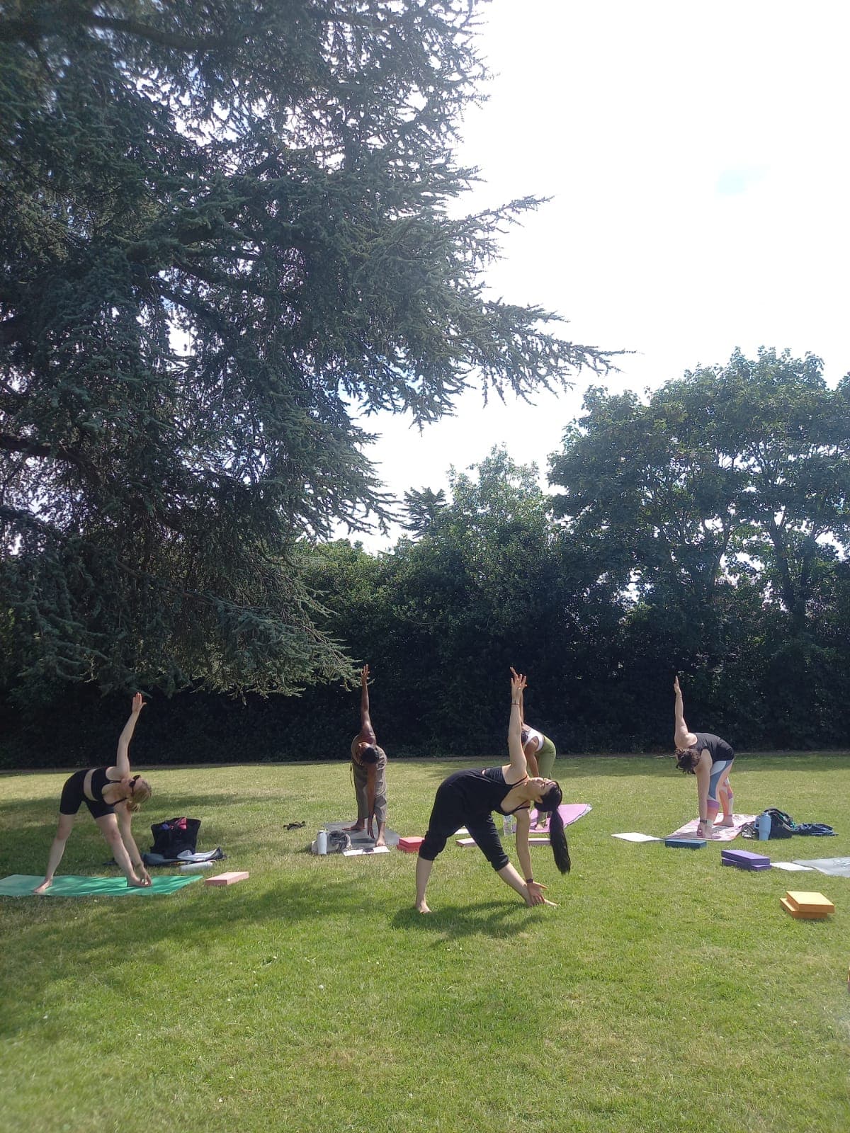 Yoga class being taught in a park